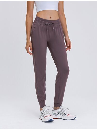 Joggers with a waist tie and pockets for comfort and style.