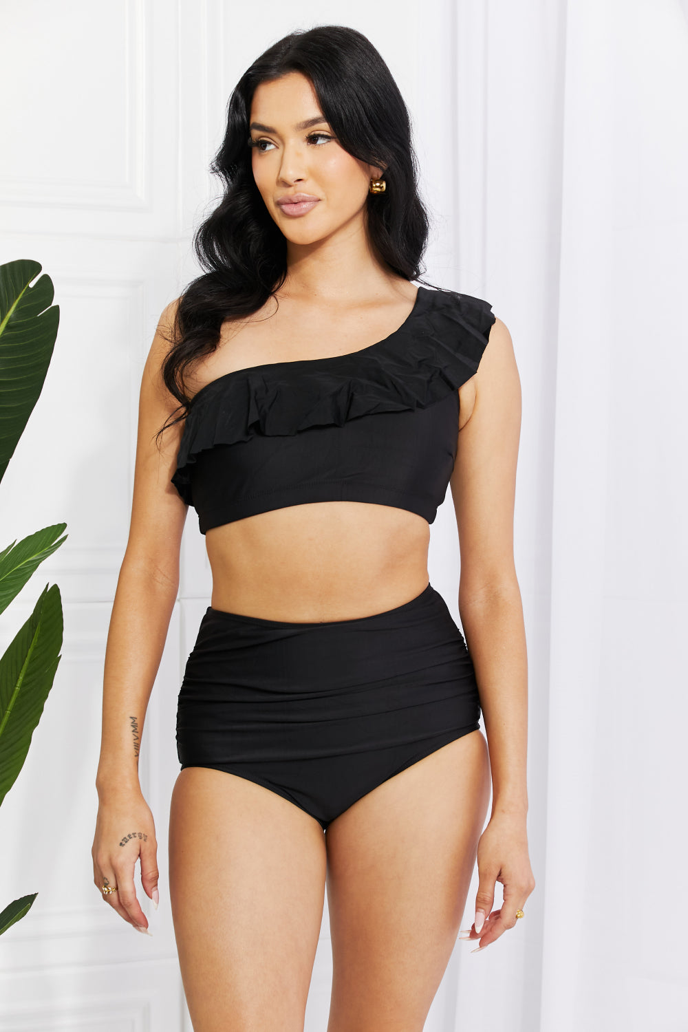 Marina West’s Seaside Romance bikini featuring a ruffled one-shoulder design in classic black